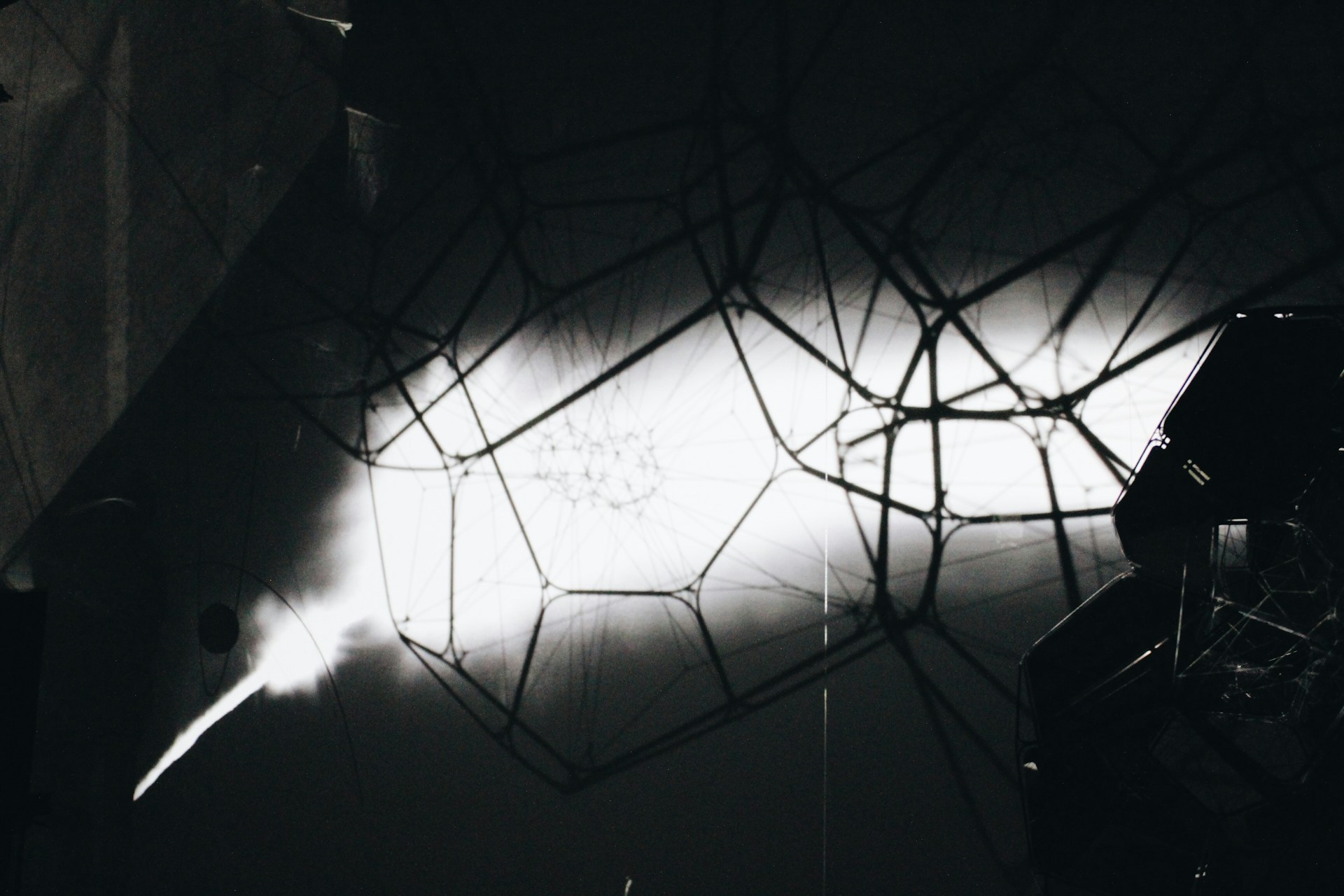 black photo with a bright white streak containing black through lines