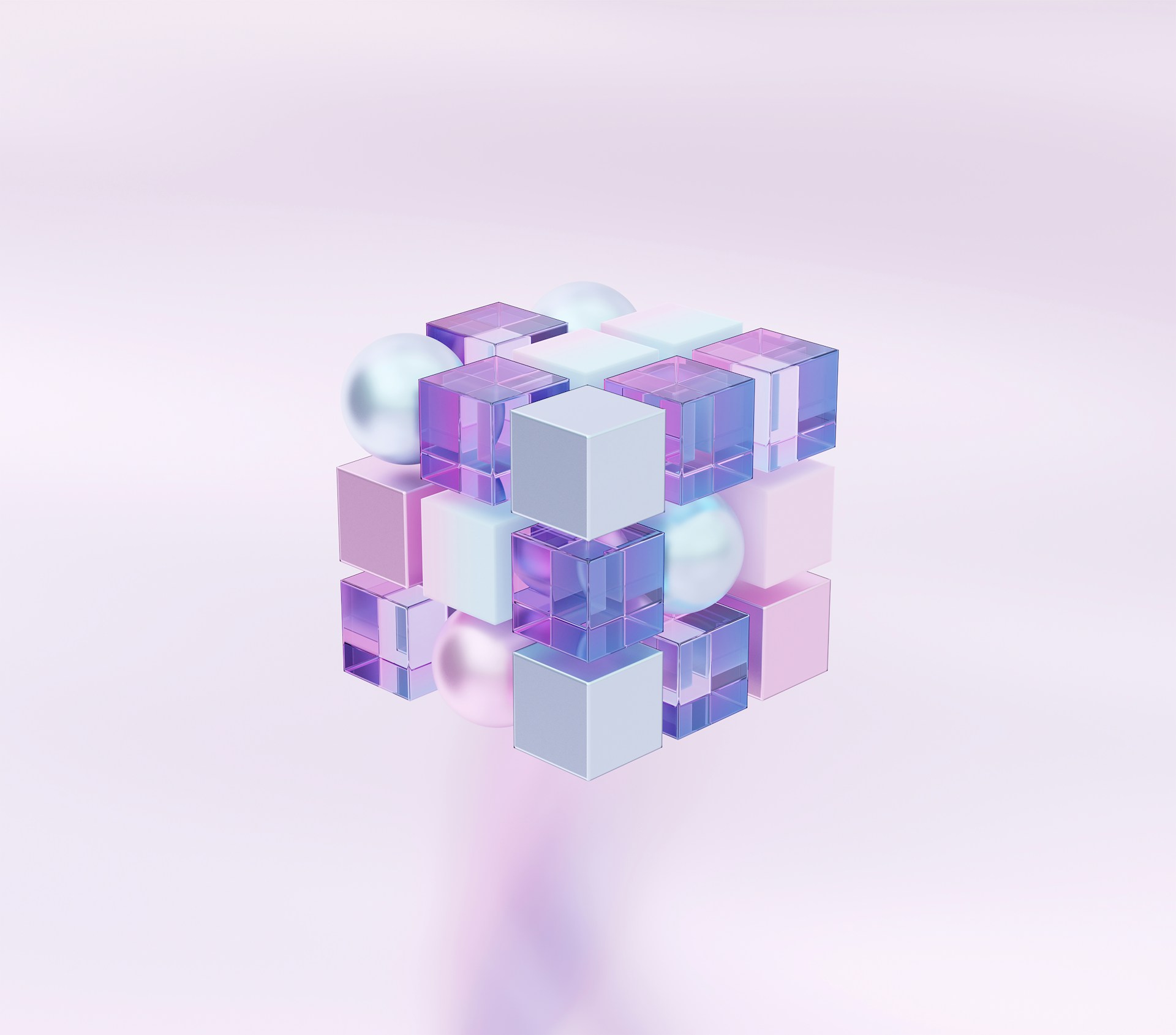 A floating cluster of geometric shapes against a soft lavender background - translucent purple glass cubes, solid pastel pink and white blocks, and pale spheres arranged in a loose cubic structure